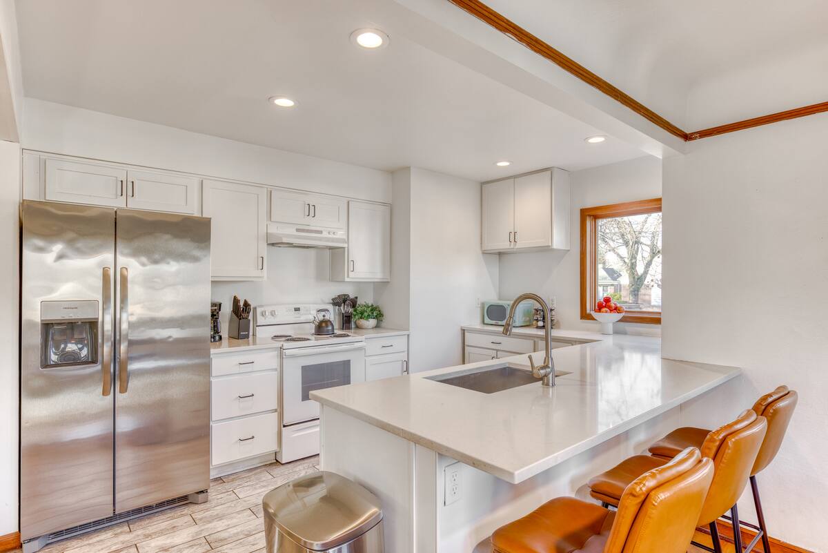Bright and Tidy White Kitchen with Everything Needed for Cooking and Dining