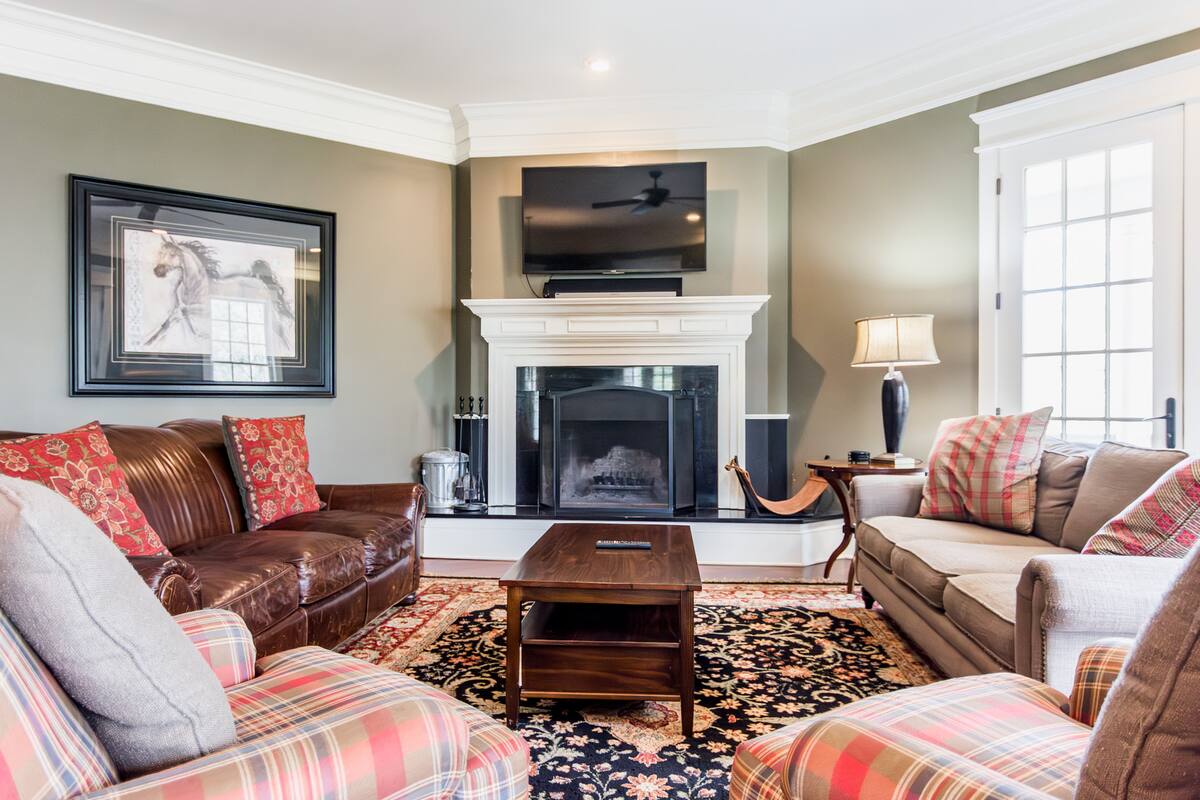 Comfortable living room with smart TV and wood burning fireplace.