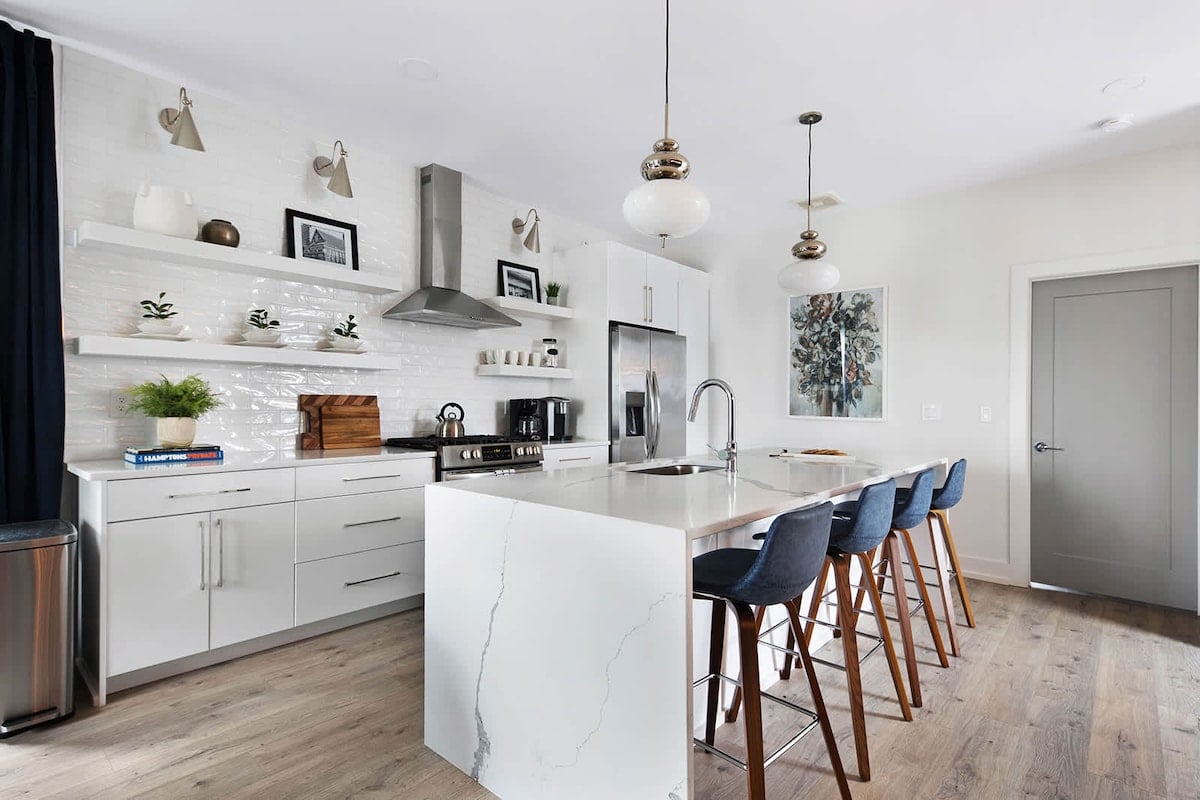 Clean and Spacious Kitchen with Sleek Countertops and Additional Seating