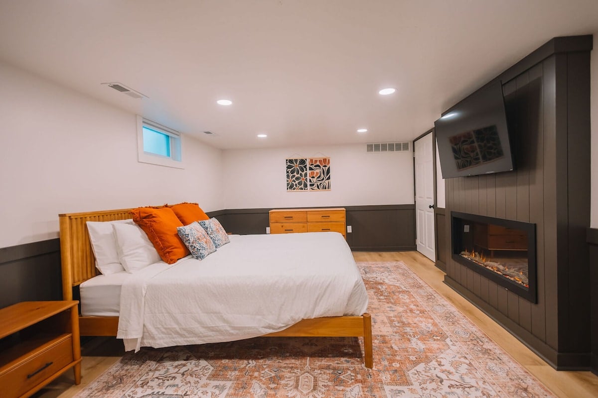 Bedroom 1 - King Bed located in the basement. This beautiful suite has its own TV, fireplace, and full bath!