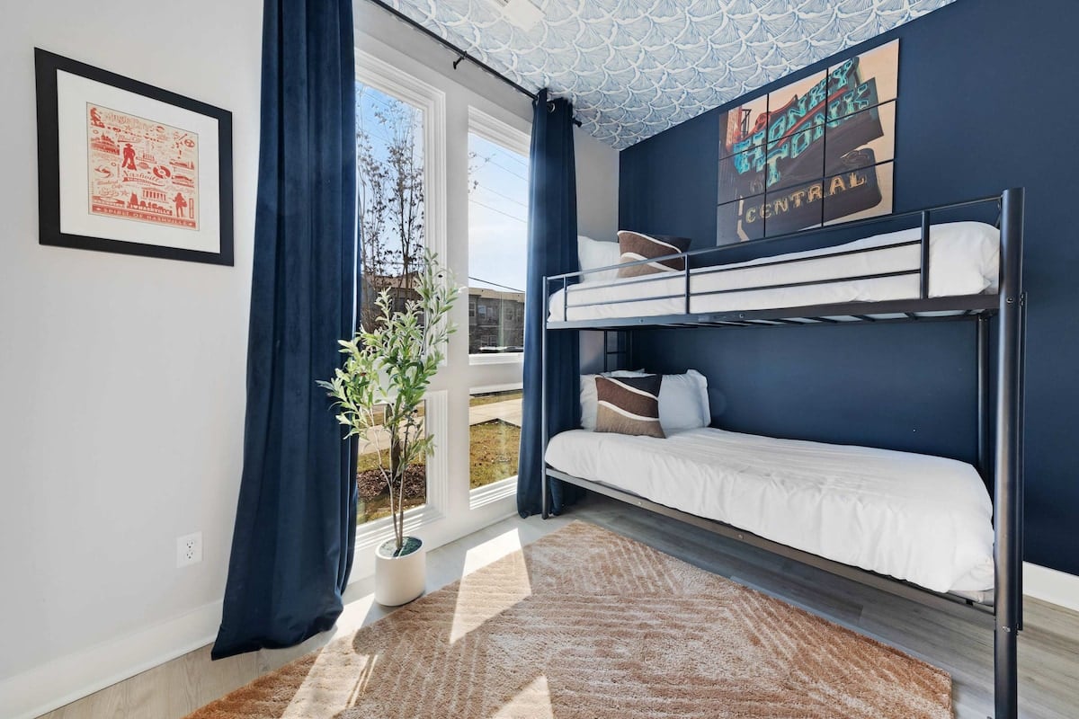 Cozy bedroom with two twin bunk beds (4 twin beds), a walk-in closet, and an en-suite bathroom with a shower for added convenience.