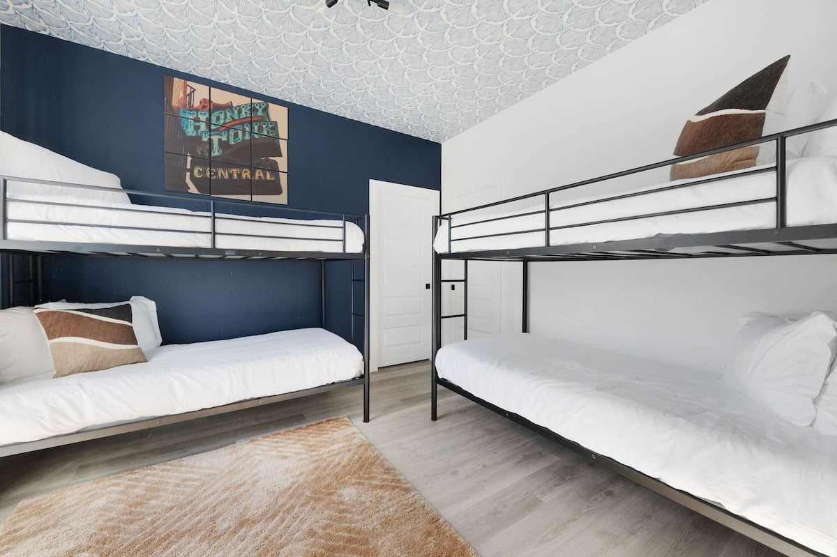 Cozy bedroom with two twin bunk beds (4 twin beds), a walk-in closet, and an en-suite bathroom with a shower for added convenience.