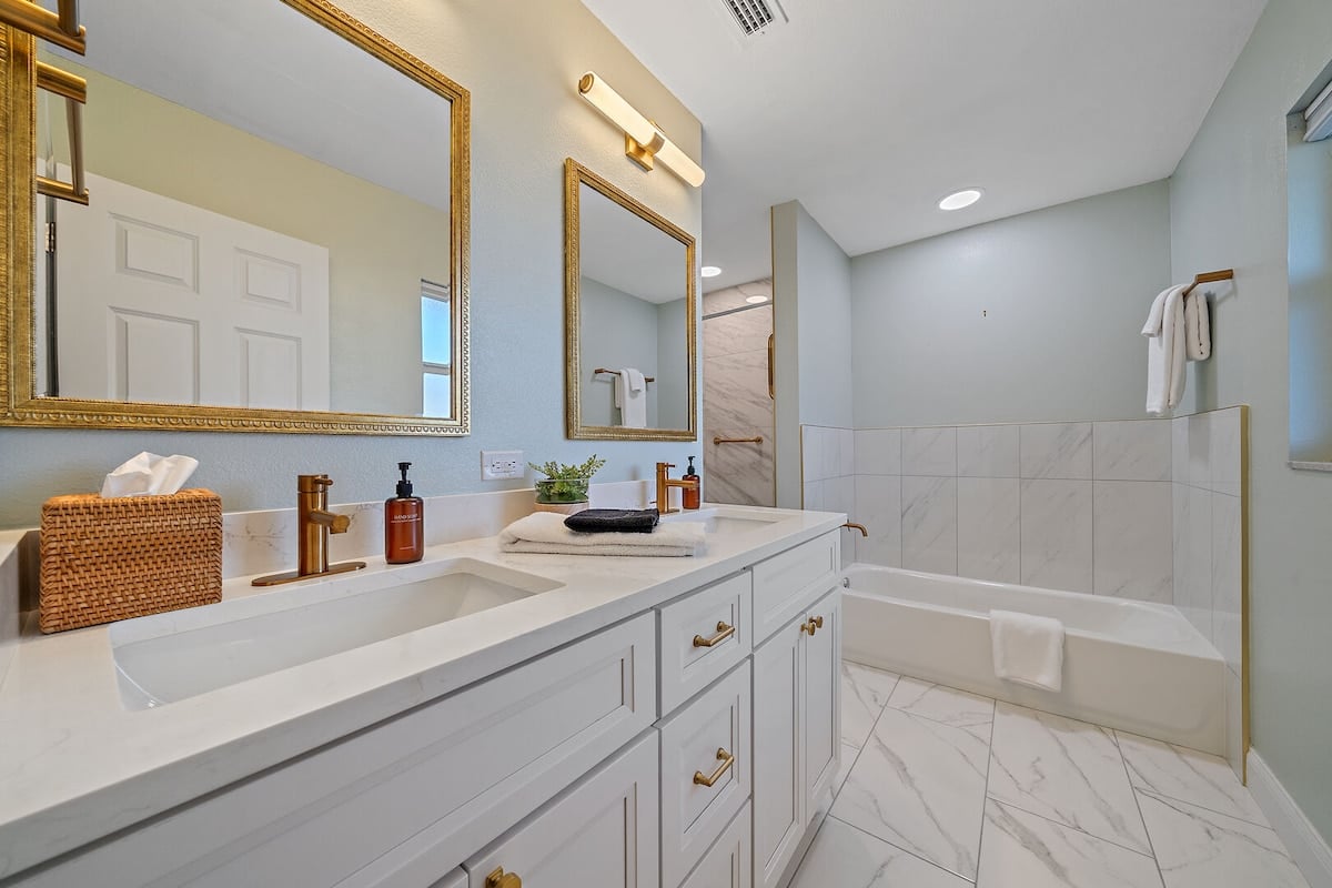 Standing shower with floor-to-ceiling tile and Bathtub to enjoy. Our home is stocked with clean and sustainable products and toiletries to give you and your loved ones a toxin-free stay!
