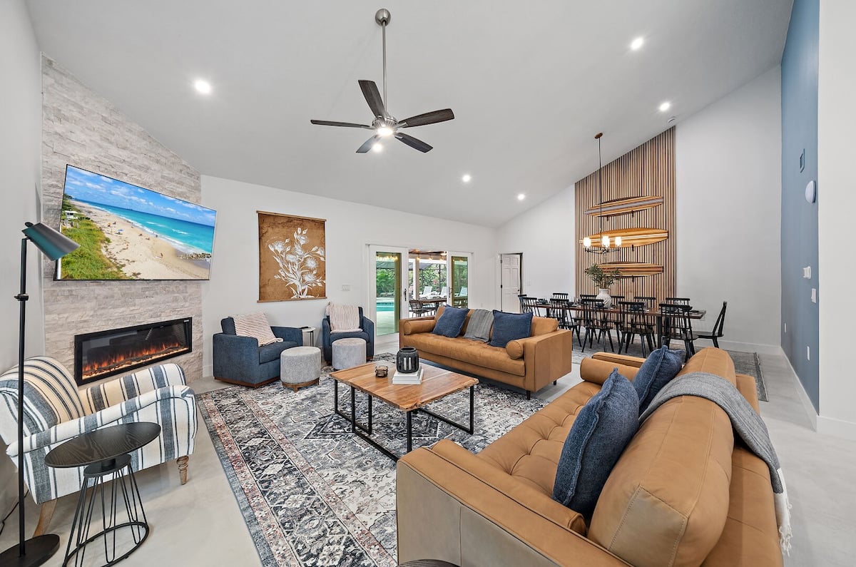 The living room of the main house has plenty of comfy seating, and a beautiful electric fireplace under the TV.