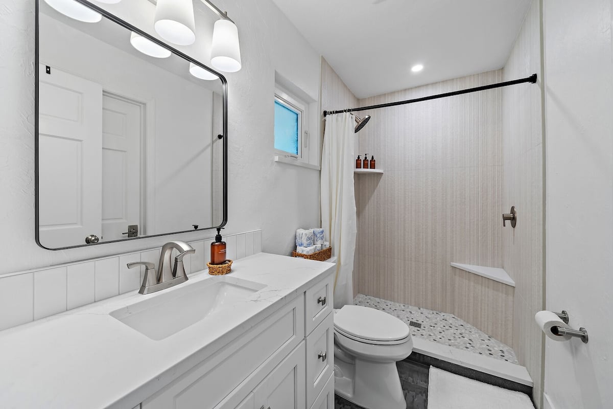 Bathroom 3 with standing shower, located in the main house hallway on the first floor.
