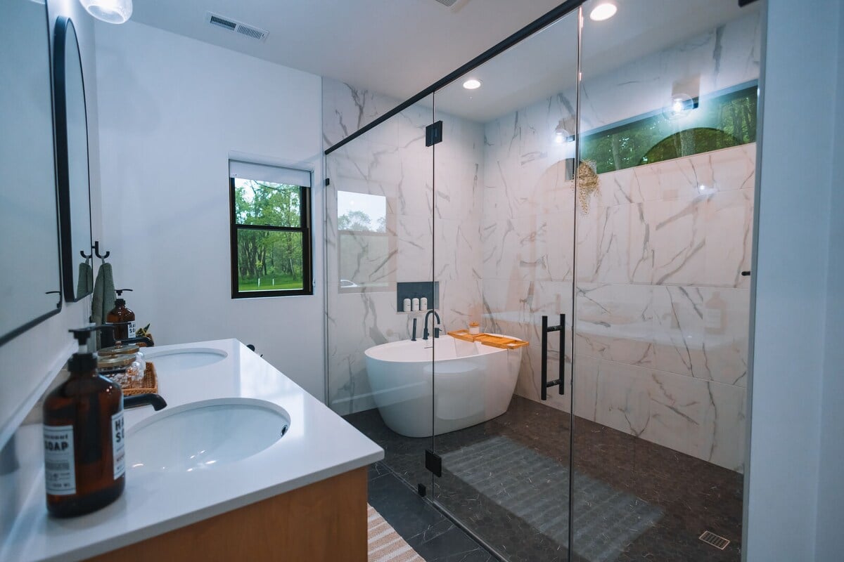 Amazing design with a double vanity and beautiful shower/tub space.