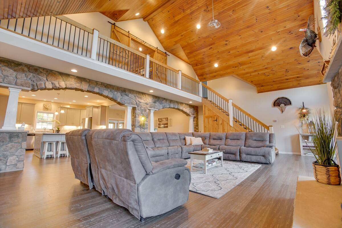 High vaulted wood ceilings open up this gorgeous living room space.