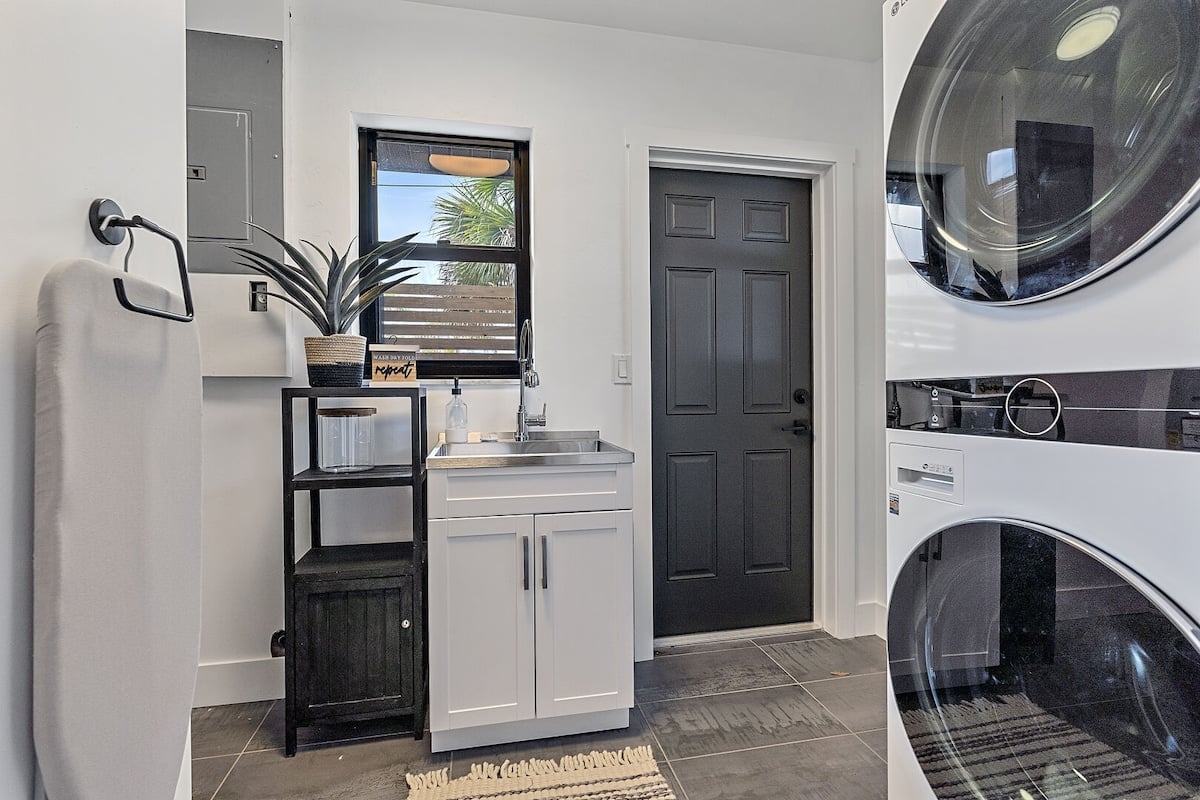 Washer and dryer access through the laundry room and connecting half bath.