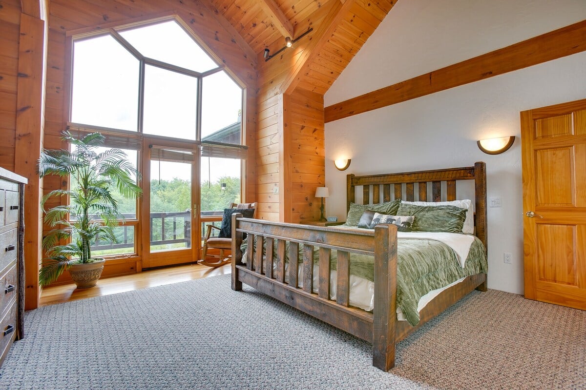 Bedroom 2 - King Bed located on the first floor with smart TV and doorway leading to the back deck.