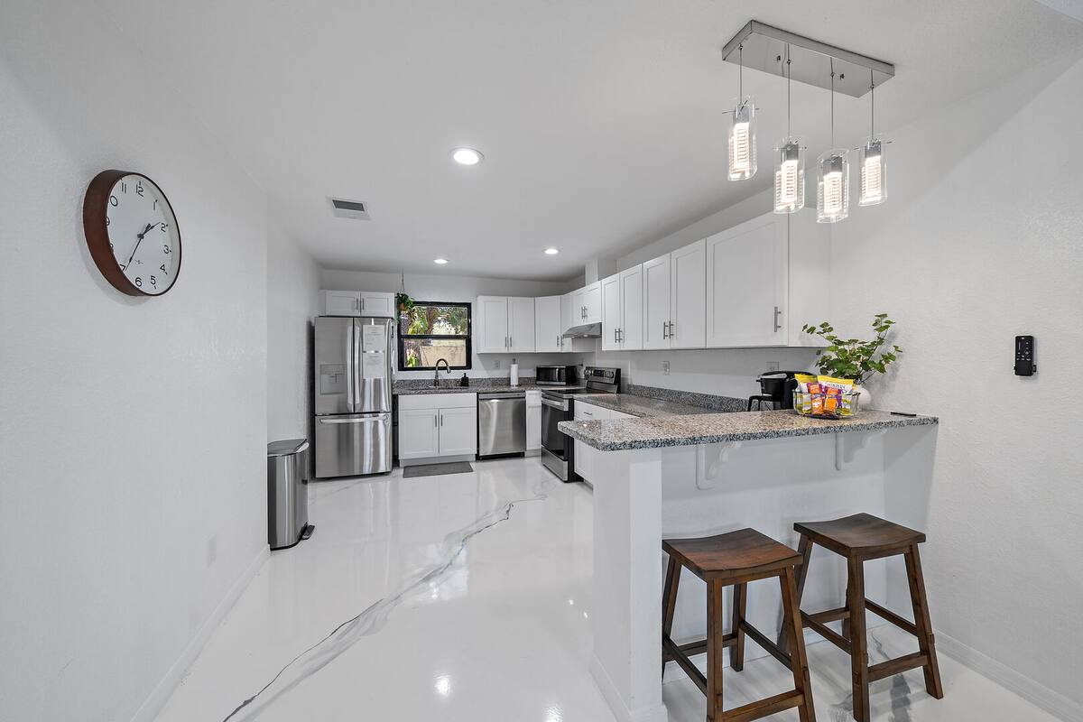 Absolutely stunning modern kitchen and bar that seats 2. The perfect spot for breakfast!