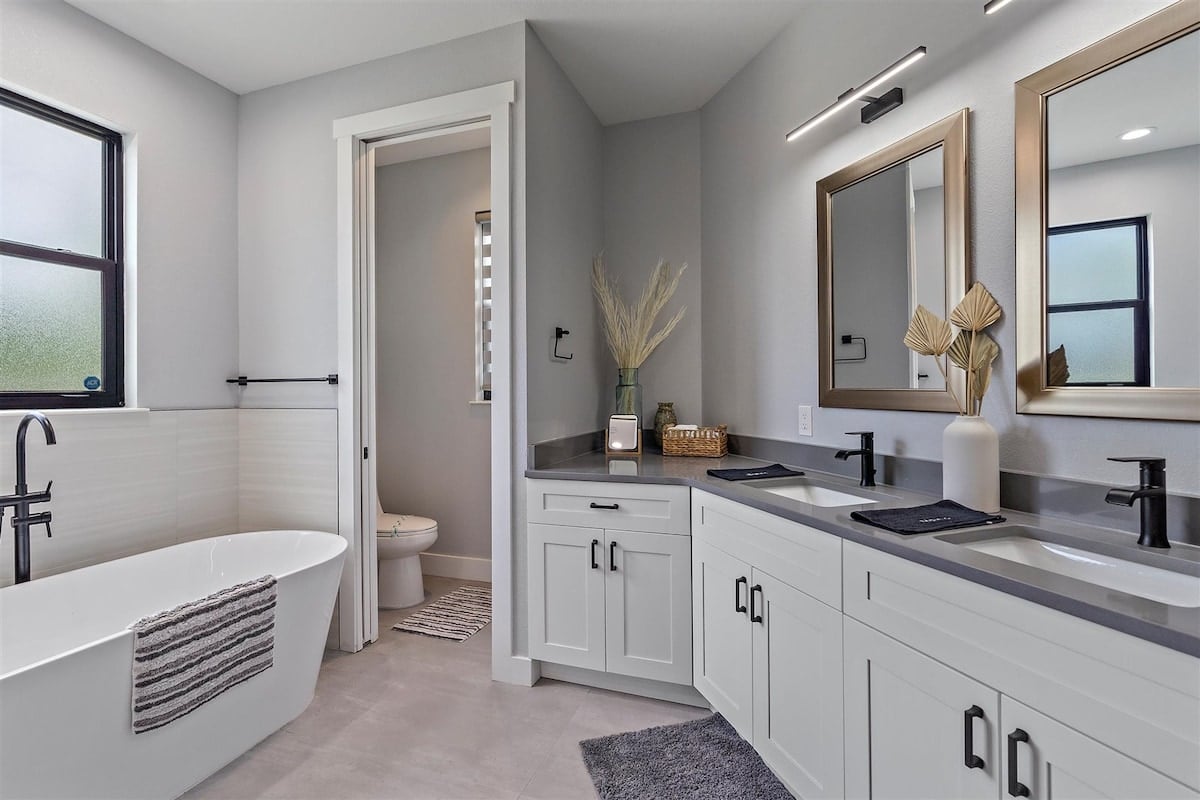 Full bathroom located in the hallway and through Bedroom 4. Has a standing shower, soaker tup, and double sink vanity!