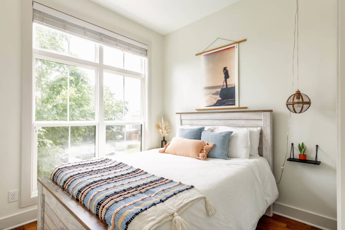 The queen bedroom features a large front-facing window and a private en-suite bathroom.
