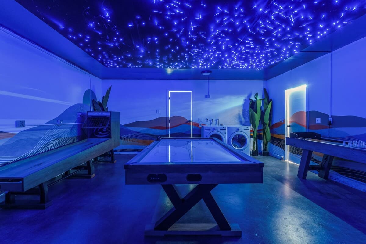Full game garage with skeeball, air hockey table and shuffleboard.