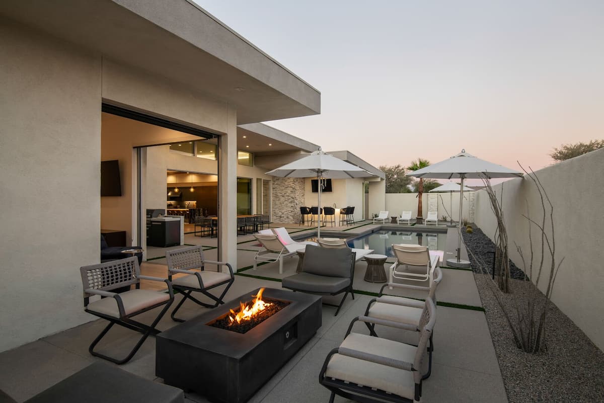 Cozy up at sunset around the outdoor fire pit and comfortable seating, with views of the mountains and the main pool area.