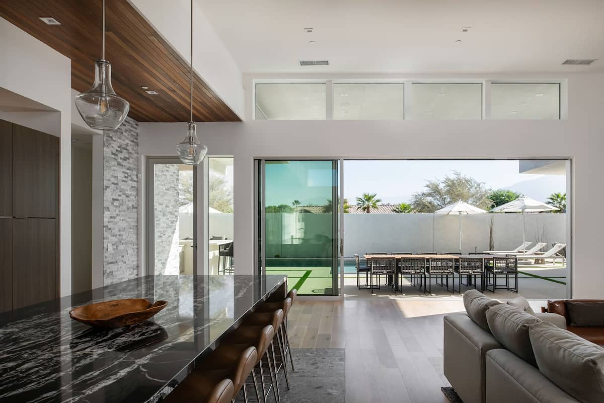 The true meaning of indoor-outdoor living: Glass sliders disappear completely, connecting the gourmet kitchen and living space to the pool patio.