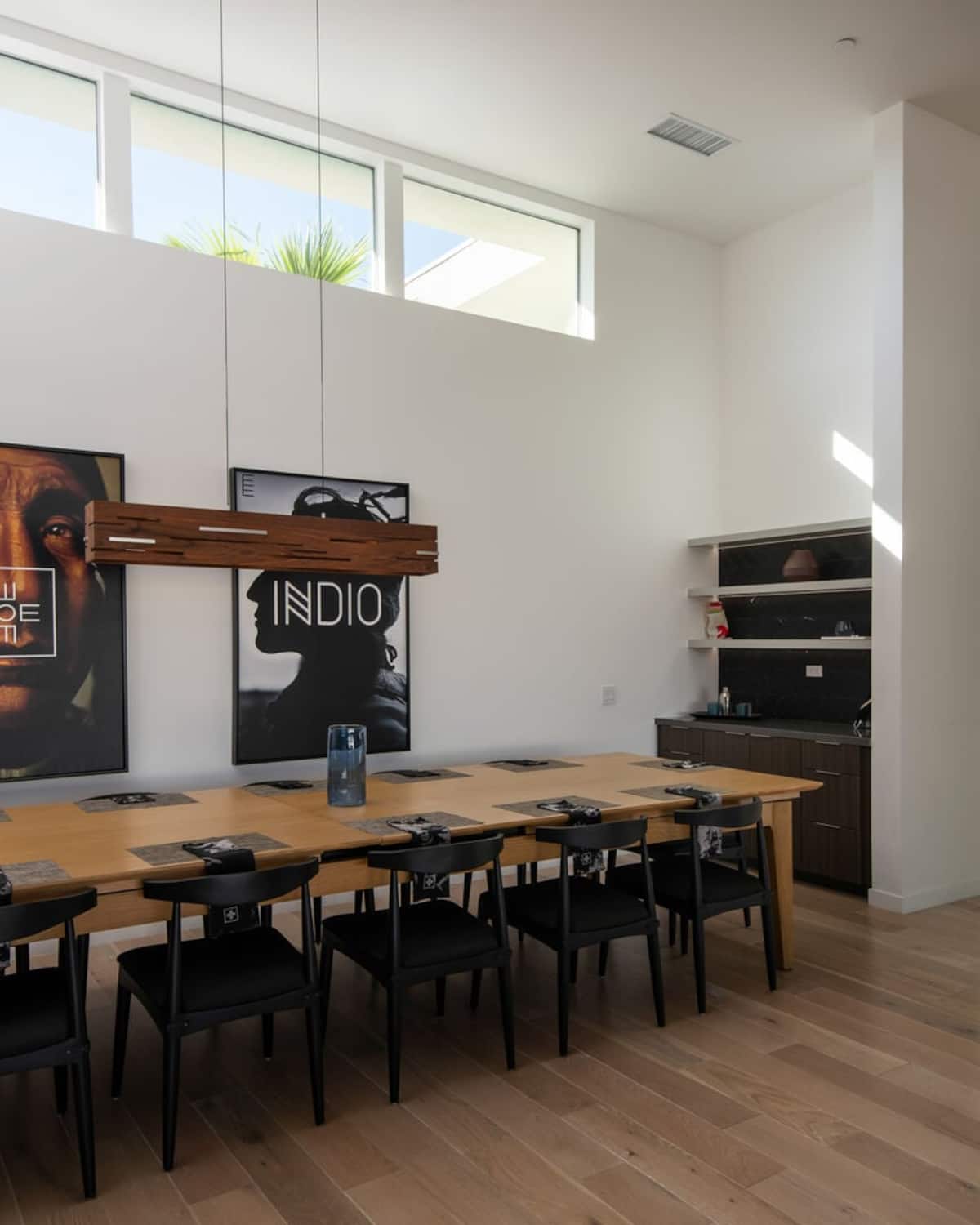 The oversized dining table for 10+ is complemented by high ceilings, ample natural light, and a convenient wet bar/coffee station.