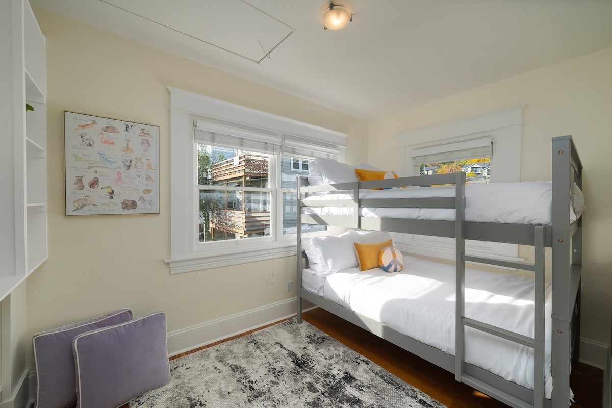 Two spacious full-size beds ensure a comfortable night's sleep. Ideal for families, offering a separate space for kids to hang out, complete with a TV for entertainment. Vibrantly decorated, this room adds a splash of color to your stay.