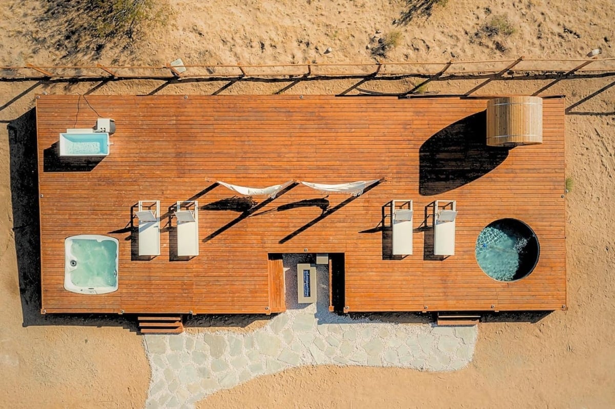 The wellness spa deck with everything you need for relaxation including a pool, cold plunge, sauna, tanning chairs, firepit, hammocks, and hot tub!