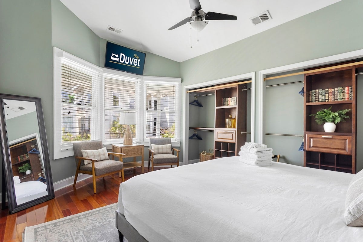 **CAPTION:** 
"Property" in Charleston exudes contemporary elegance with its airy atmosphere and sophisticated architectural design. The interior features a calming palette of muted greens and warm woods, enhanced by natural light from expansive windows. Plush furnishings and thoughtful decor contribute to its inviting ambiance, perfect for discerning travelers seeking tranquility and modern comforts. The meticulously curated space offers a serene retreat amidst the vibrant Charleston setting, merging luxury and relaxation effortlessly.