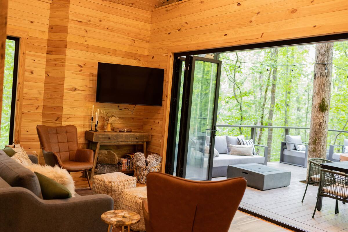 Living room with nano wall open to outdoor living room on deck...indoor/outdoor living at its finest