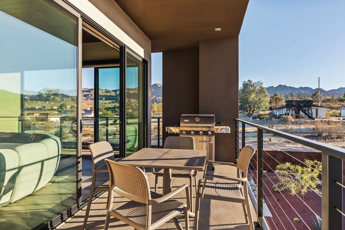 Balcony off the main living room features a BBQ.