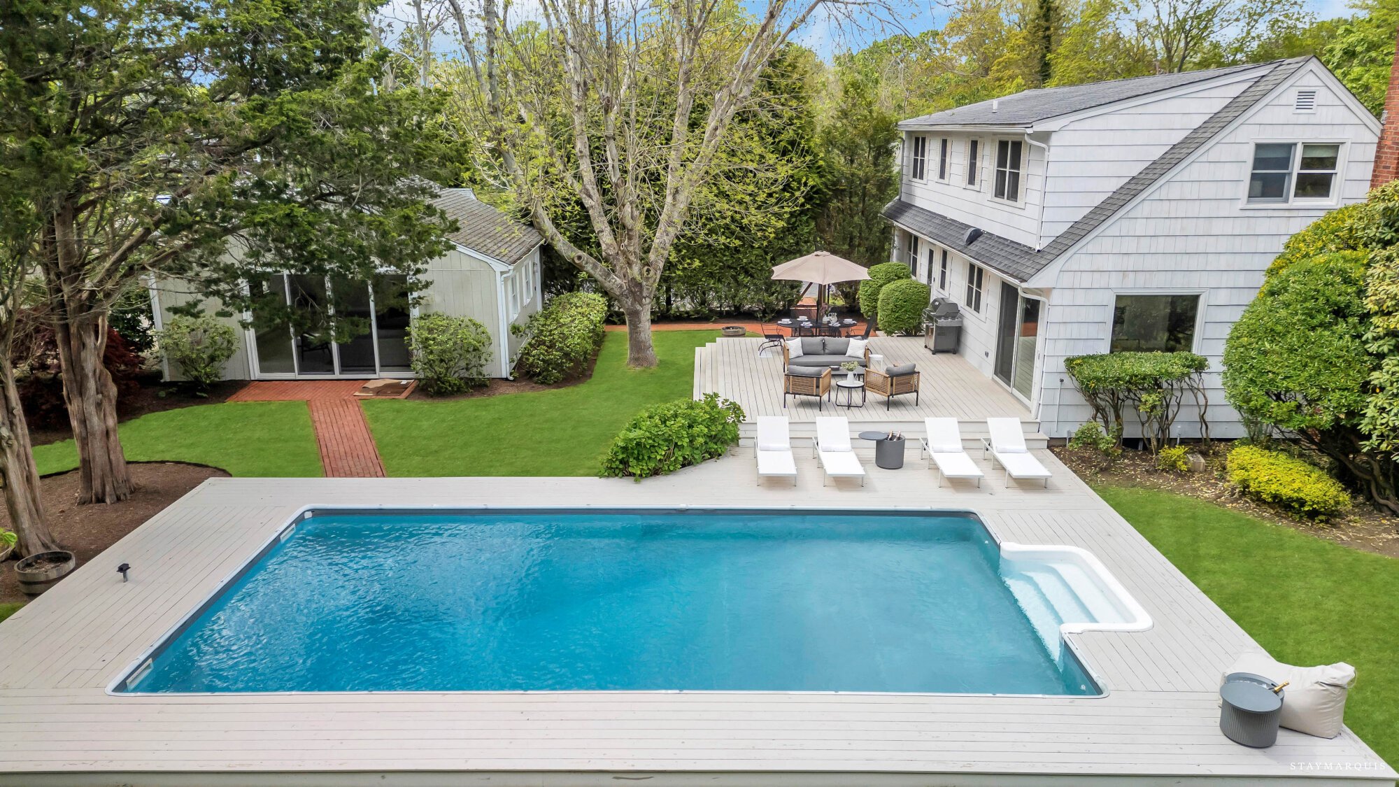 Clean lines and summer light on a quiet East Hampton lane in East Hampton, NY