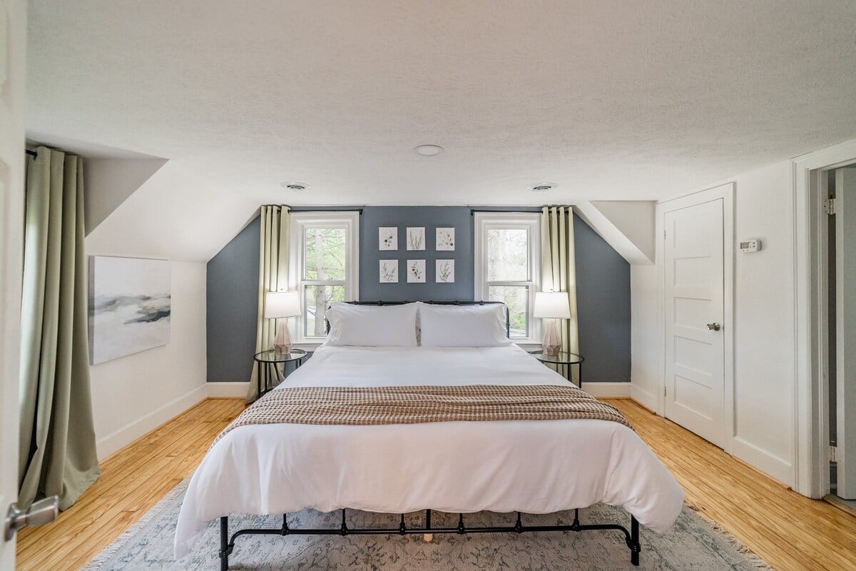 Bedroom includes king bed, TV, dresser, mini fridge and Keurig