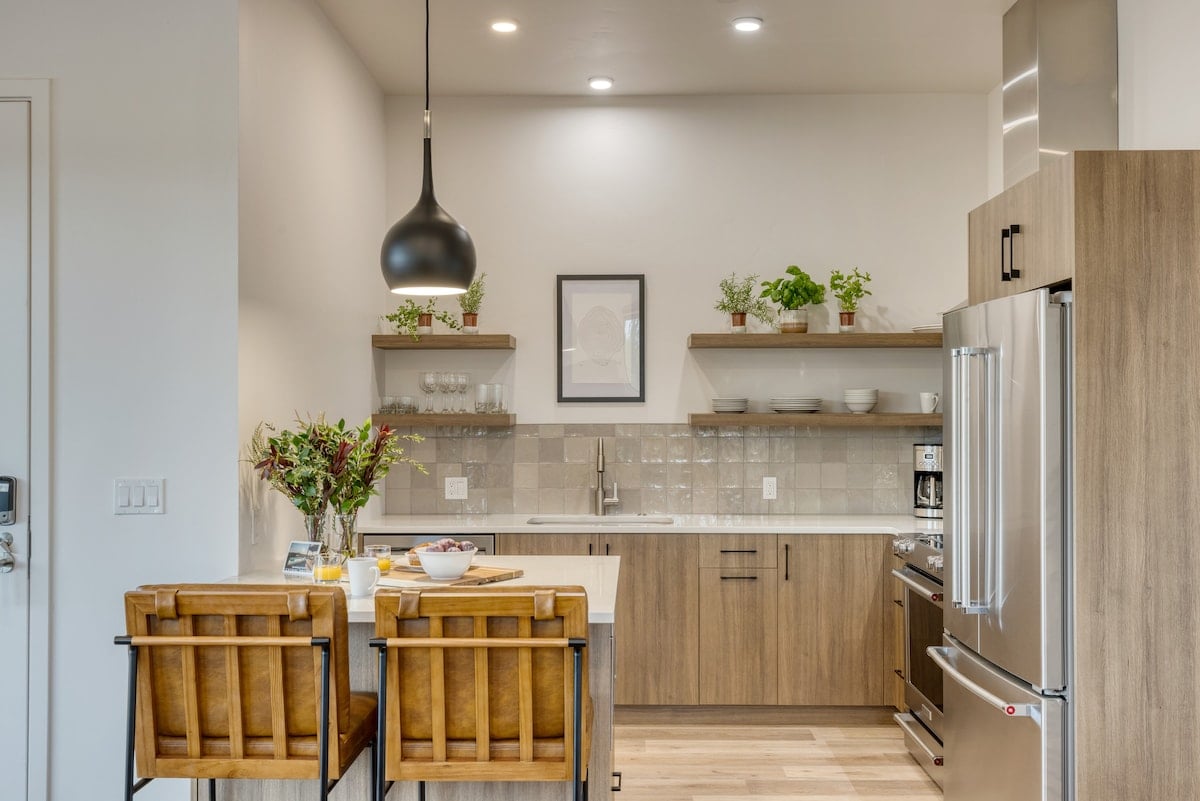 Stylish kitchen with island seating and open shelving.