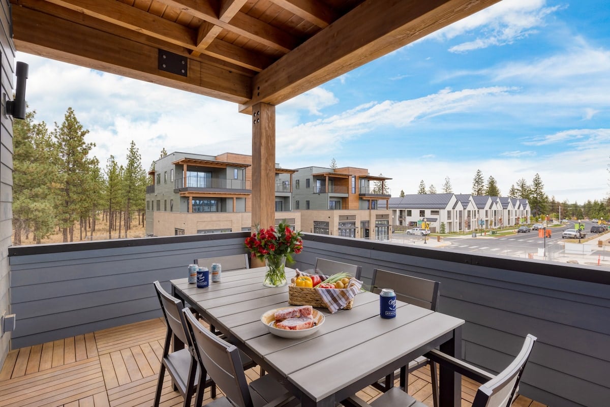 Covered private balcony with dining area and grill.