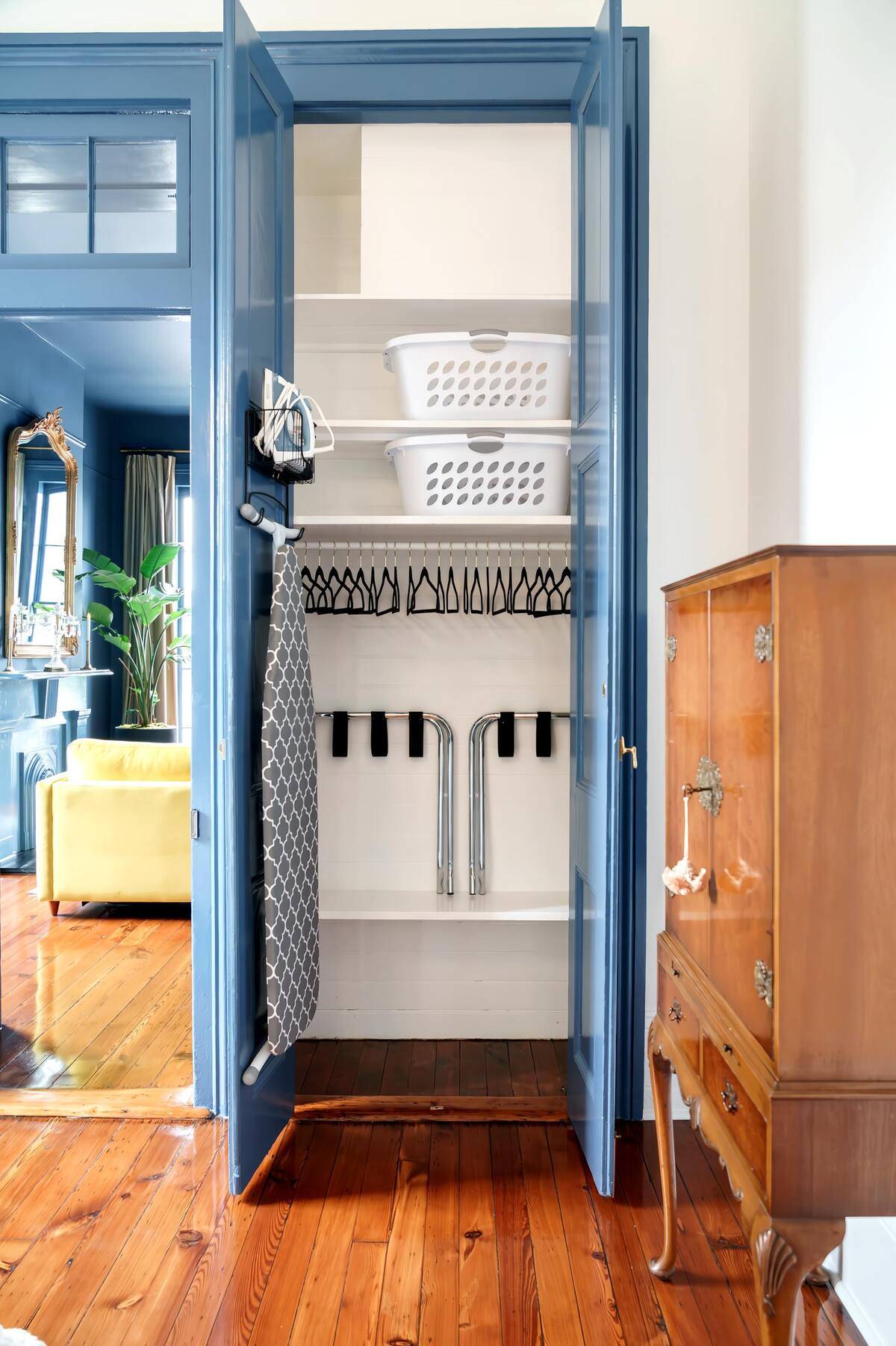 Well equipped closet with iron, ironing board, hangers, luggage racks, extra storage.
