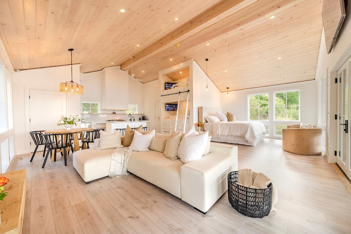 The main area, open-floor plan: living room, dining room and master bedroom, bunk beds and kitchen. The bathroom is separated by double doors 