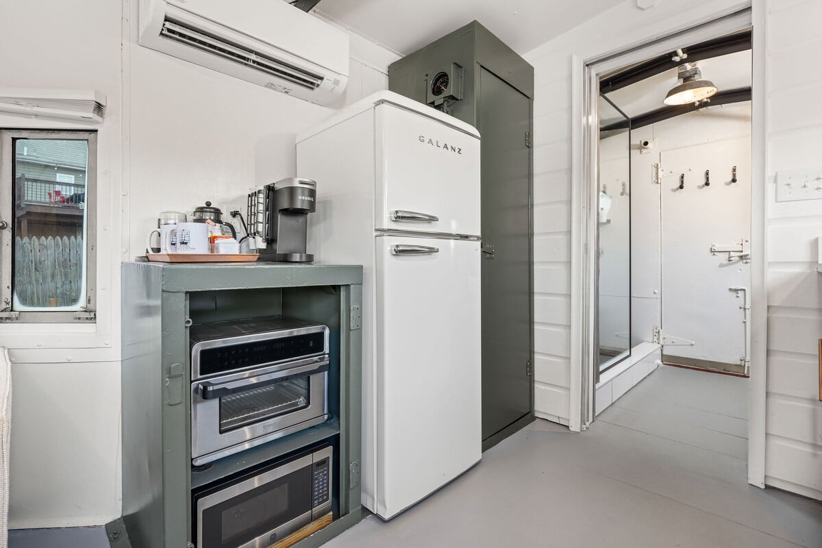 Kitchen has a microwave, a small convection oven, and a fridge with freezer.