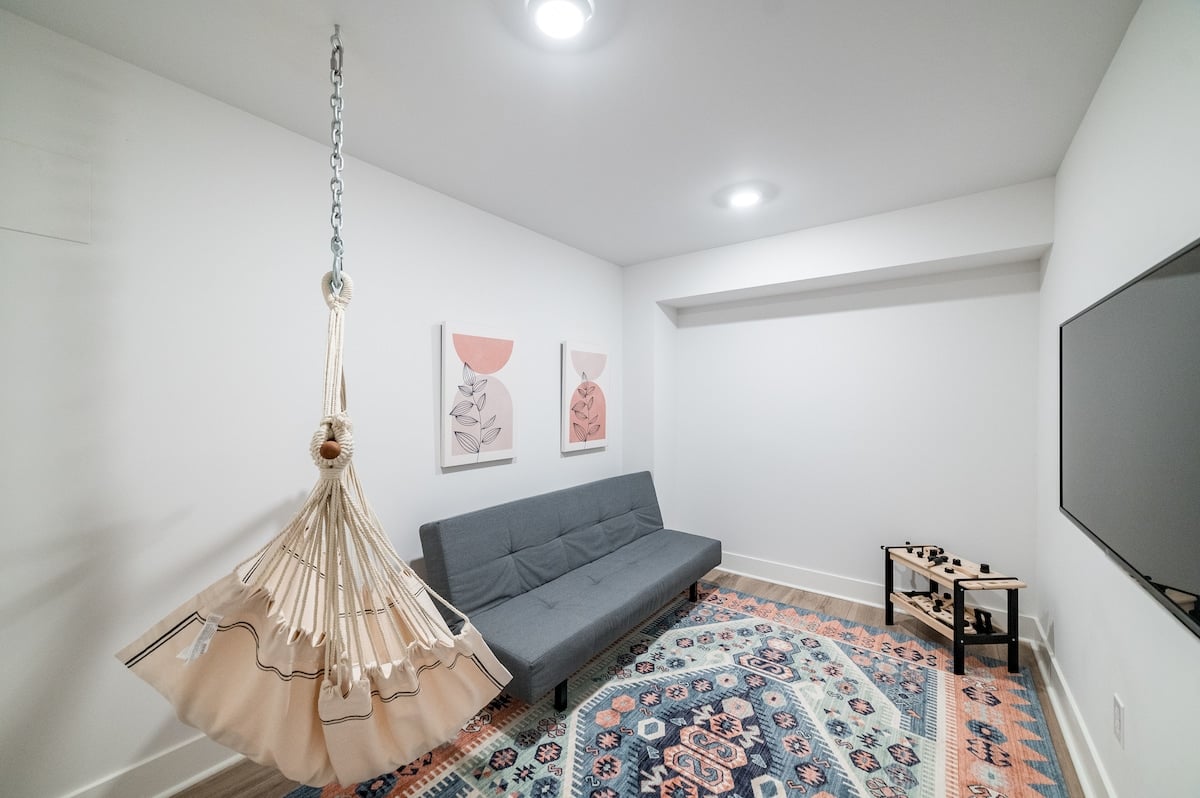 Basement bonus room! Smart TV, futon, hanging chair, and kids' tool bench