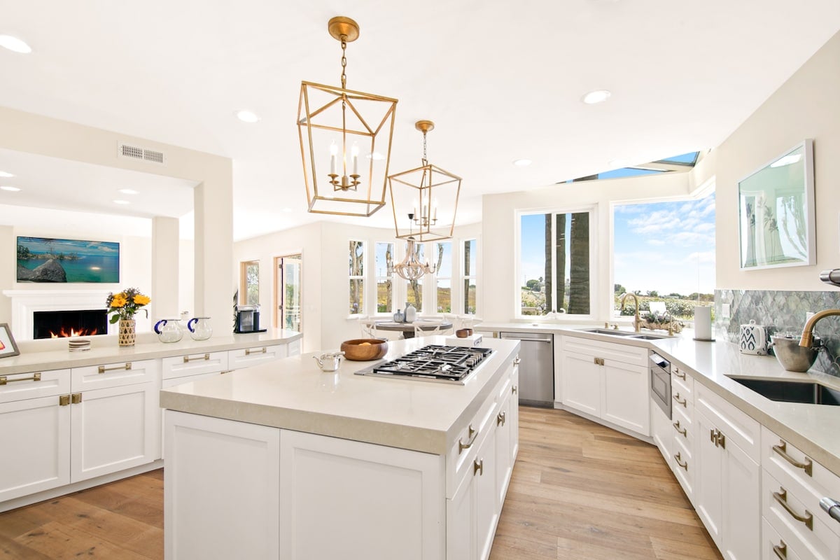 An entertainers dream kitchen with upgraded appliances overlooking the luxury outdoor space.