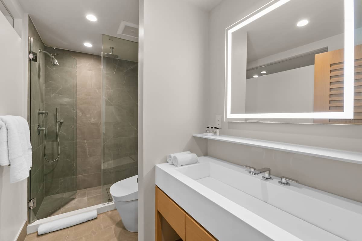 High end finishings include a glass framed shower with a Graff rain shower