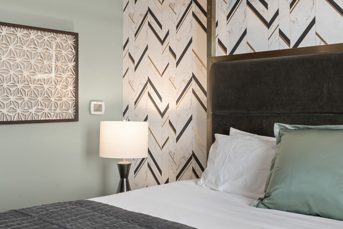 Thoughtful design details, layered textures, and a serene color palette create a boutique-style retreat with king bed. 