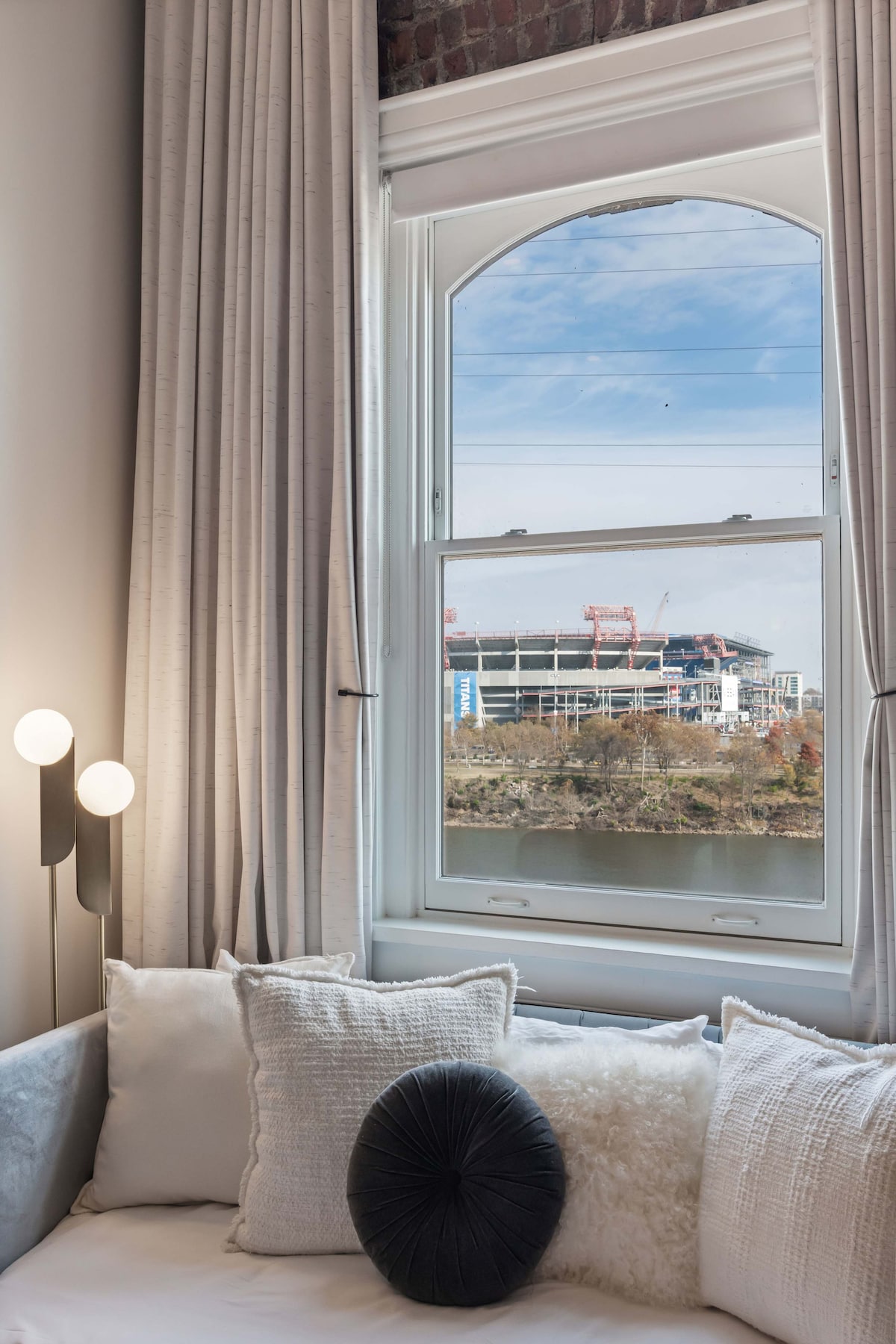 River-view king suite with a cozy twin daybed overlooking the Cumberland and the Titans stadium.