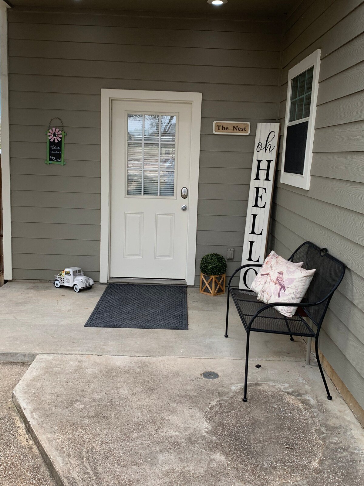 Private entrance with an adjacent deck with a string of twinkle lights. Deck has a table and chairs for dining, playing games, or relaxing. 