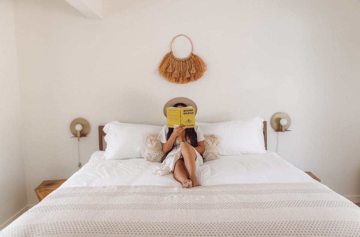 "Todos Santos" suite with king bed, double closets, reading nook with views of Joshua Tree National Park, and glass sliding doors that open onto patio and outdoor shower 
