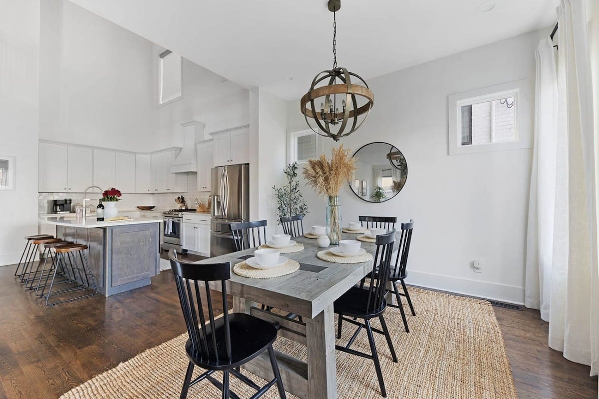
The large farm-style dining table and open concept design create an inviting space, perfect for great conversation.