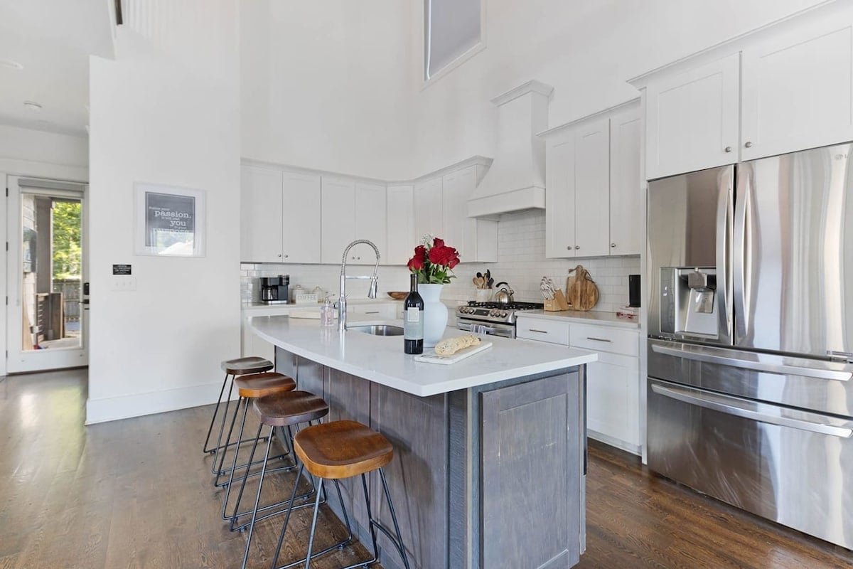 White cabinets, a large island, and upgraded appliances provide a fantastic space to create and enjoy delicious meals.