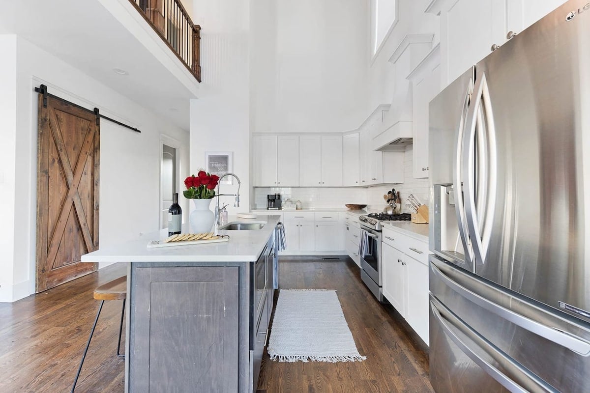 The kitchen is filled with natural light, thanks to its open design and soaring two-story ceilings.