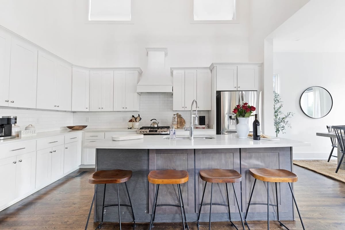 The kitchen island has bar stool seating for 4 guests