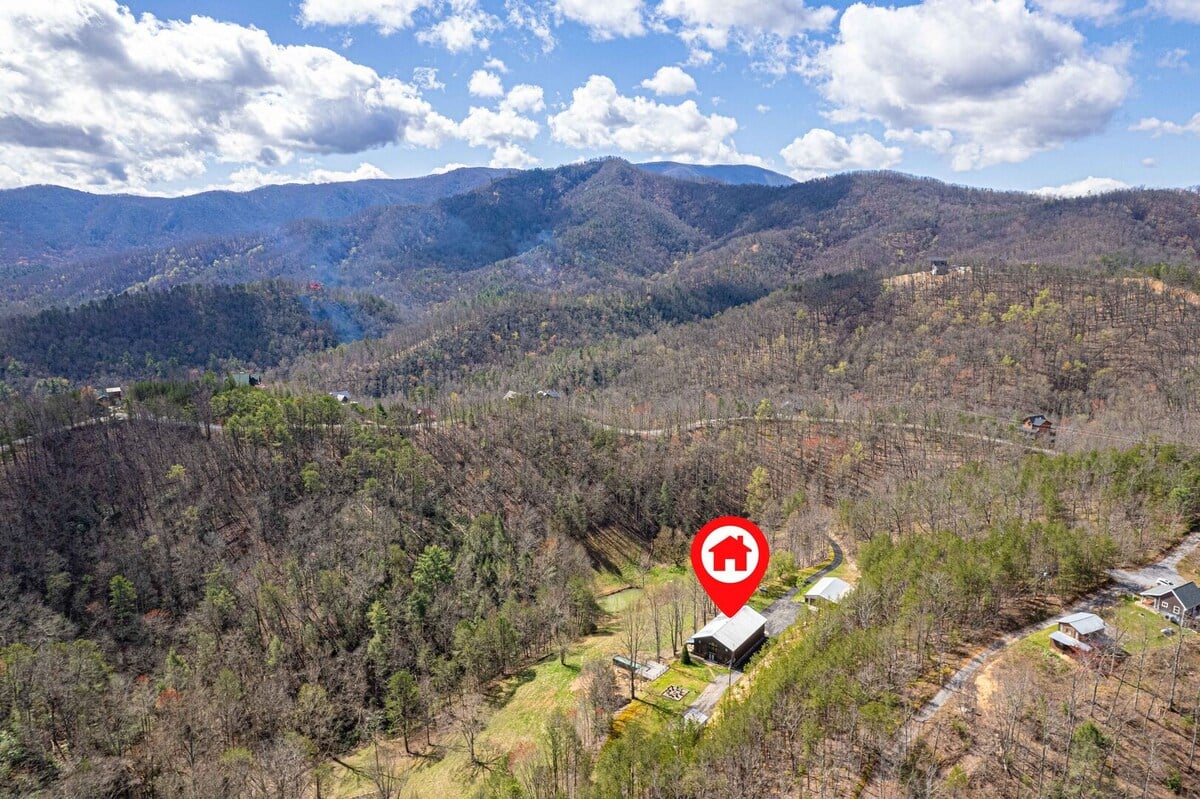 Steel, stone, and wide-open sky at a mountaintop retreat built for gathering in Pigeon Forge, TN