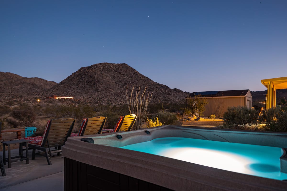 Soak in the hot tub overlooking the beautiful desert mountain views