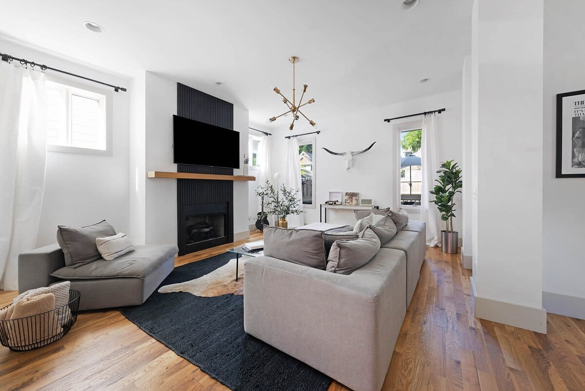 The perfect gathering space with a fireplace, smart television, oversized sectional, and record player. 