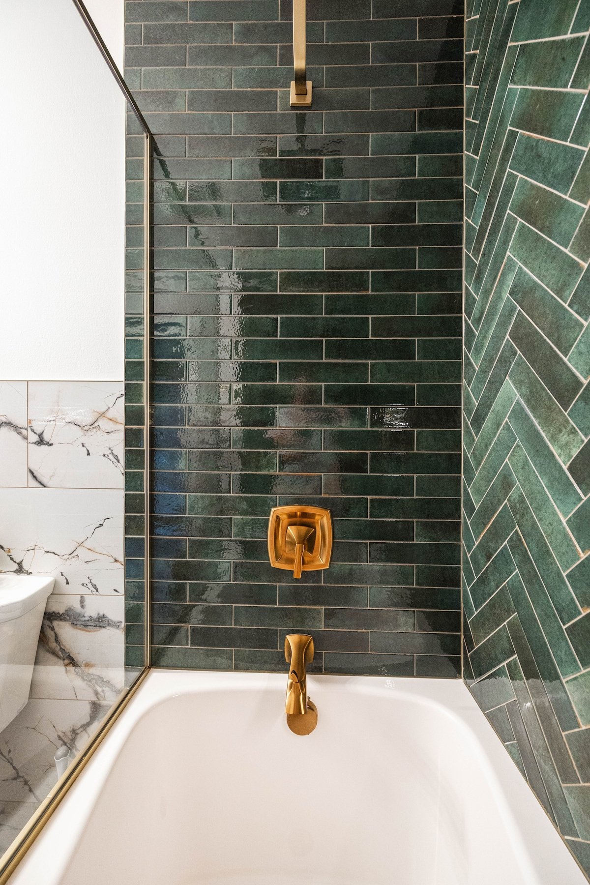 Indulge in a soothing soak in the freestanding bathtub or enjoy a refreshing rain shower surrounded by sleek and modern design.