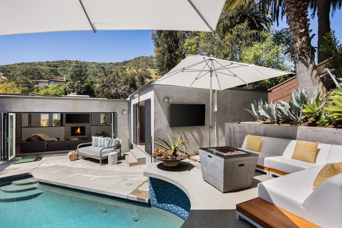 Discover the allure of the poolside fire pit, surrounded by plush seating.