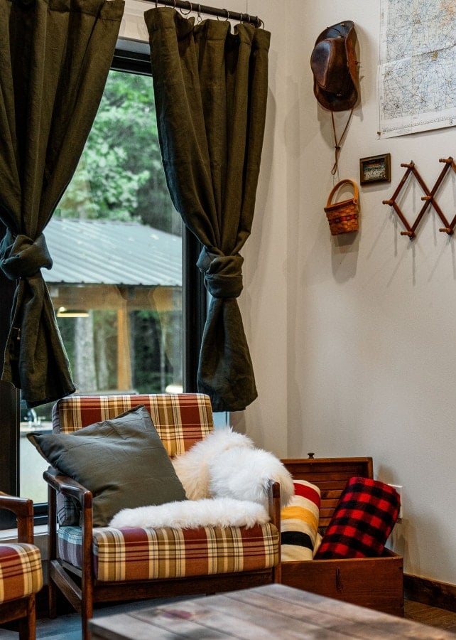 The living room features a record player with Bluetooth speaker capability, a 50" smart TV with YouTube TV subscription, and a couch that converts into a queen-size sleeper sofa.