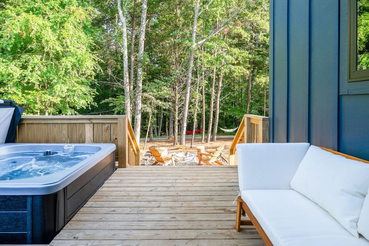 Enjoy your private deck featuring a hot tub, outdoor seating, and a wood-burning fire pit just steps away.